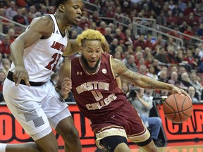 Boston College guard Ky Bowman (0) attempts to drive past Louisville center Steven Enoch (23) during the first half of an NCAA college basketball game in Louisville, Ky., Wednesday, Jan. 16, 2019.