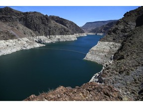FILE - This May 31, 2018 file photo shows the reduced water level of Lake Mead behind Hoover Dam in Arizona. Arizona is nearing a deadline to approve a plan to ensure a key reservoir in the West doesn't become unusable as a water source for farmers, cities, tribes and developers. Other Western states are watching. The U.S. Bureau of Reclamation expects full agreement on a drought contingency plan by Thursday, Jan. 31, 2019.