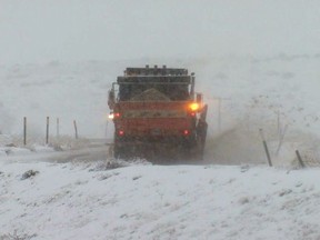 This photo provided by KGET-TV shows a CalTrans snow removal vehicle clearing a roadway on Interstate 5 where it has been closed due to snow at Tejon Pass, an area known as the Grapevine, at Gorman in the Tehachapi Mountains of Southern California Monday, Jan. 14, 2019. The first in a series of Pacific storms is moving across Southern California, where downpours could unleash mud and debris flows from large wildfire burn scars. (KGET-TV via AP)