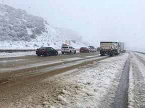 This photo provided by the California Department of Transportation shows traffic stopped on Interstate 5 where it has been closed due to snow at Tejon Pass, an area known as the Grapevine, at Gorman in the Tehachapi Mountains of Southern California, Monday, Jan. 14, 2019. The first in a series of Pacific storms is moving across Southern California, where downpours could unleash mud and debris flows from large wildfire burn scars. (CalTrans via AP)