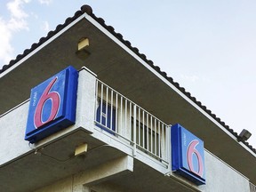 FILE - This Sept. 14, 2017, file photo shows a Motel 6 in Phoenix. A federal judge in Phoenix will review terms of a settlement in the class-action lawsuit filed by Motel 6 guests who say employees of the national budget chain shared their private information with immigration officials.
