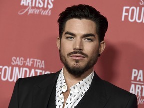 FILE - In this Nov. 8, 2018 file photo, actor Adam Lambert arrives at the Patron of the Artists Awards at the Wallis Annenberg Center for the Performing Arts in Beverly Hills, Calif. Los Angeles police have arrested Benjamin Eitan Ackerman, 32, who they say burglarized the Hollywood Hills homes of celebrities, including Lambert, after casing them while pretending to be a potential buyer or real estate agent during open houses. Detective Jared Timmons said Wednesday, Jan. 2, 2019, that investigators have seized more than 2,000 items worth several million dollars allegedly taken in burglaries in 2017 and 2018.