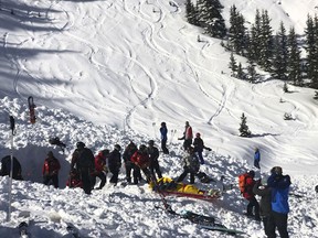 People search for victims after an avalanche buried multiple people near the highest peak of Taos Ski Valley, one of the biggest resorts in New Mexico, Thursday, Jan. 17, 2019. The avalanche rushed down the mountainside of the New Mexico ski resort on Thursday, injuring at least a few people who were pulled from the snow after a roughly 20-minute rescue effort, a resort spokesman said.