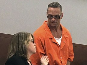 FILE - In this Aug. 17, 2017, file photo, Nevada death row inmate Scott Raymond Dozier, right, confers with Lori Teicher, a federal public defender involved in his case, during an appearance in Clark County District Court in Las Vegas. Authorities say the 48-year-old Nevada death-row inmate who wanted for two years to die, but whose execution was postponed twice, has been found dead in his cell on Saturday, Jan. 5, 2019, from an apparent hanging.