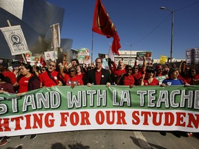 In this Saturday, Dec. 15, 2018, photo, thousands of teachers rally against the nation's second-largest school district in downtown Los Angeles. A massive teachers strike in Los Angeles is all but inevitable starting Monday, Jan. 14, 2019, after the two sides did not renew negotiations over the weekend.
