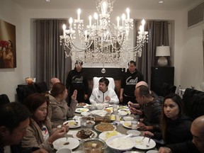 FILE - In this Jan. 14, 2019, file photo, boxer Manny Pacquiao, center, eats breakfast with friends and relatives following his morning run in Los Angeles. A spokesman for boxer Manny Pacquiao says the famed fighter's Los Angeles home was robbed at about the time he was in the ring with rival Adrien Broner in Las Vegas. Spokesman Mike Quinn confirmed the burglary to NBC News. Los Angeles police said a burglary was reported about 4:15 p.m. Sunday, Jan. 20, 2019. in the Larchmont neighborhood.