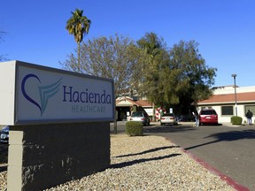 FILE - This Friday, Jan. 4, 2019, file photo shows Hacienda HealthCare in Phoenix. State regulators reportedly wanted to remove developmentally disabled patients from a Phoenix long-term care facility years before a woman in a vegetative state gave birth. The Arizona Republic reported Sunday, Jan. 13, 2019, that Hacienda HealthCare faced a criminal investigation in 2016. The facility allegedly billed the state some $4 million in bogus 2014 charges for wages, transportation, housekeeping, maintenance and supplies.