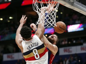 Detroit Pistons forward Blake Griffin is blocked by New Orleans Pelicans center Jahlil Okafor (8) as he goes to the basket in the first half of an NBA basketball game in New Orleans, Wednesday, Jan. 23, 2019.