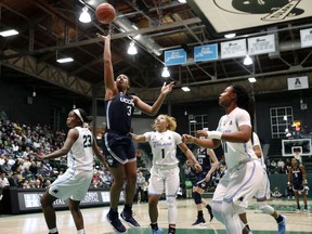 Connecticut guard Megan Walker (3) goes to the basket over Tulane guard Kaila Anderson (1), forward Krystal Freeman (23) and guard Tatyana Lofton (11) in the first half of an NCAA college basketball game in New Orleans, Wednesday, Jan. 16, 2019.