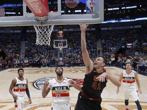 Cleveland Cavaliers center Ante Zizic (41) goes to the basket against New Orleans Pelicans forward Anthony Davis (23) in the first half of an NBA basketball game in New Orleans, Wednesday, Jan. 9, 2019.
