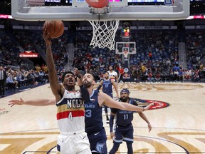 New Orleans Pelicans guard Elfrid Payton (4) goes to the basket against Memphis Grizzlies center Marc Gasol in the first half of an NBA basketball game in New Orleans, Monday, Jan. 7, 2019.