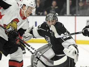 Los Angeles Kings left wing Ilya Kovalchuk, right, blocks a shot with his stick as Ottawa Senators left wing Rudolfs Balcers, left, battles in front of the net and goaltender Jonathan Quick watches during the first period of an NHL hockey game Thursday, Jan. 10, 2019, in Los Angeles.