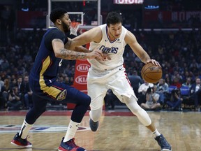 Los Angeles Clippers' Danilo Gallinari, right, dribbles against New Orleans Pelicans' Anthony Davis during the first half of an NBA basketball game Monday, Jan. 14, 2019, in Los Angeles.