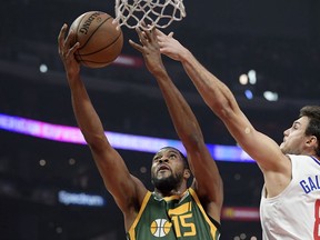 Utah Jazz forward Derrick Favors, left, shoots as Los Angeles Clippers forward Danilo Gallinari defends during the first half of an NBA basketball game, Wednesday, Jan. 16, 2019, in Los Angeles.