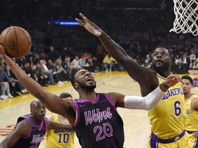 Minnesota Timberwolves guard Josh Okogie, left, shoots as Los Angeles Lakers guard Lance Stephenson defends during the first half of an NBA basketball game Thursday, Jan. 24, 2019, in Los Angeles.