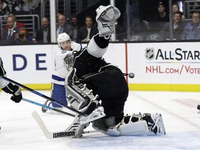 Los Angeles Kings goaltender Jonathan Quick, center, gives up a goal on a shot from Tampa Bay Lightning's Brayden Point, background, during the first period of an NHL hockey game Thursday, Jan. 3, 2019, in Los Angeles.