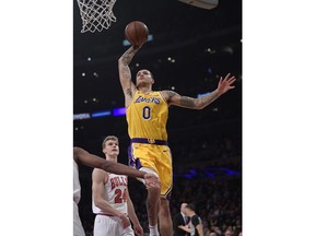 Los Angeles Lakers forward Kyle Kuzma goes up for a dunk as Chicago Bulls forward Lauri Markkanen watches during the first half of an NBA basketball game Tuesday, Jan. 15, 2019, in Los Angeles.