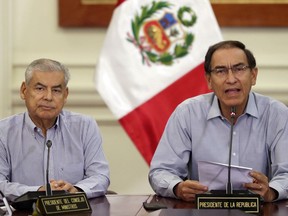 Peru's President Martin Vizcarra, right, speaks next to Prime Minister Cesar Villanueva at the government palace in Lima, Peru, Tuesday, Jan. 1, 2019. Vizcarra will call on Peru's congress to declare the attorney general's office in a state of emergency after Attorney General Pedro Chavarry abruptly dismantled a team investigating several former presidents suspected of corruption.