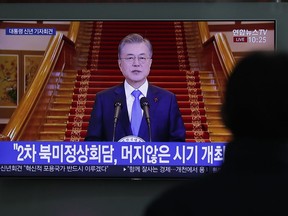A man watches a TV screen showing a live broadcast of South Korean President Moon Jae-in's New Year speech at the Seoul Railway Station in Seoul, South Korea, Thursday, Jan. 10, 2019. The letters read "Second summit between North Korea and United States.  South Korea's President Moon has suggested he'll push for sanction exemptions to restart dormant economic cooperation projects with North Korea.