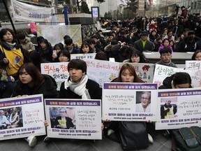 Participants hold pictures of the deceased Kim Bok-dong, one of the many former South Korean sex slaves who were forced to serve for the Japanese military in World War II, during a weekly rally near the Japanese Embassy in Seoul, South Korea, Wednesday, Jan. 30, 2019. Hundreds of South Koreans are mourning the death of a former sex slave for the Japanese military during World War II by demanding reparations from Tokyo over wartime atrocities.