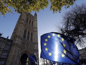 The sun shines through European Union flags tied to railings outside parliament in London, Tuesday, Jan. 22, 2019. British Prime Minister Theresa May unveiled her Brexit Plan B on Monday -- and it looks a lot like Plan A. May launched a mission to resuscitate her rejected European Union divorce deal, setting out plans to get it approved by Parliament after securing changes from the EU to a contentious Irish border measure.