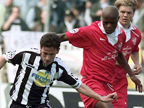 FILE - In this Sunday, April 11, 1998 file photo, Udinese's Pineda, left, challenges for the ball with Bari's Phil Masinga, at the Udine stadium in Udine Italy. Phil Masinga, the former South Africa and Leeds United striker who scored the goal that took his country to the World Cup for the first time, has died at the age of 49 it was announced Sunday, Jan. 13, 2019.