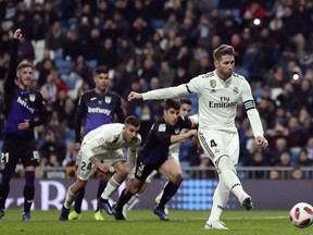 Real Madrid's Sergio Ramos, right, scores a penalty during a Spanish Copa del Rey soccer match between Real Madrid and Leganes at the Bernabeu stadium in Madrid, Spain, Wednesday, Jan. 9, 2019.