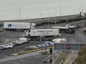 Trucks take part in a no-deal Brexit test, by driving through Dover near the ferry port whilst testing a route from Manston Airfield where 6,000 trucks could be parked as an overspill customs option in south east England, Monday, Jan. 7, 2019. Britain is testing how its motorway and ferry system would handle a no-deal Brexit by sending a stream of trucks from a regional airport to the port of Dover -- even as some legislators try to pressure the government to rule out the scenario.