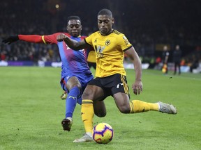 Wolverhampton's Ivan Cavaleiro, right, plays the ball as Crystal Palace's Aaron Wan-Bissaka defends during a Premier League soccer match at Molineux, Wednesday, Jan. 2, 2019, in Wolverhampton, England.