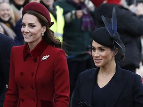 FILE - In this Tuesday, Dec. 25, 2018 file photo, Britain's Kate, Duchess of Cambridge, left, and Meghan, Duchess of Sussex arrive to attend the Christmas day service at St Mary Magdalene Church in Sandringham in Norfolk, England. The British press on Tuesday Jan. 29, 2019, is urging social media users to tone down inappropriate criticism of Meghan, the Duchess of Sussex, and Catherine, the Duchess of Cambridge.