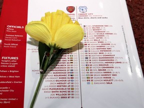 The match day programme for Arsenal and Cardiff is displayed for photographers, featuring the squad lists with the name of Emiliano Sala alongside a Daffodil, before the English Premier League soccer match at the Emirates Stadium in London, Tuesday Jan. 29, 2019.  Tonight should have been the debut match for Emiliano Sala, who is believed to have died in a plane crash Monday Jan. 21.