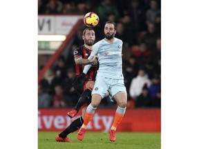 Bournemouth's Steve Cook, left, and Chelsea's Gonzalo Higuain during their English Premier League soccer match at the Vitality Stadium in Bournemouth, Wednesday Jan. 30, 2019.