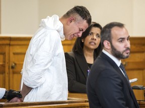 Victor Pena, left, is arraigned on kidnapping charges at the Charlestown Division of the Boston Municipal Court in Charlestown, Mass., Wednesday, Jan. 23, 2019. Pena's defense attorney Joseph Perullo, right, and an interpreter stand by his side. Pena, who has been charged with kidnapping a 23-year-old woman in Boston has been ordered to undergo a mental health evaluation and will be held without bail.