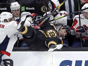 Boston Bruins defenseman Zdeno Chara is checked into the Washington Capitals bench by Washington Capitals left wing Alex Ovechkin, left, during the first period of an NHL hockey game Thursday, Jan. 10, 2019, in Boston.