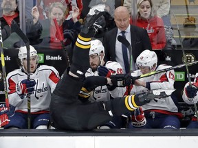 Boston Bruins defenseman Zdeno Chara is checked into the Washington Capitals bench during the first period of an NHL hockey game Thursday, Jan. 10, 2019, in Boston.