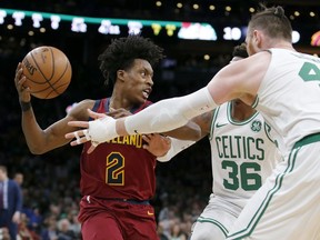 Cleveland Cavaliers guard Collin Sexton (2) looks to pass as Boston Celtics guard Marcus Smart (36) and center Aron Baynes (46) defend during the first half of an NBA basketball game, Wednesday, Jan. 23, 2019, in Boston.