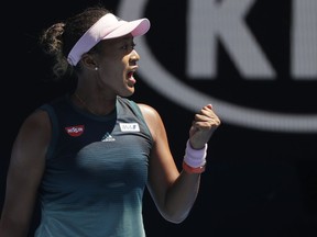 Japan's Naomi Osaka reacts after winning the first set against Ukraine's Elina Svitolina during their quarterfinal match at the Australian Open tennis championships in Melbourne, Australia, Wednesday, Jan. 23, 2019.