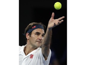 Switzerland's Roger Federer serves to United States' Taylor Fritz during their third round match at the Australian Open tennis championships in Melbourne, Australia, Friday, Jan. 18, 2019.