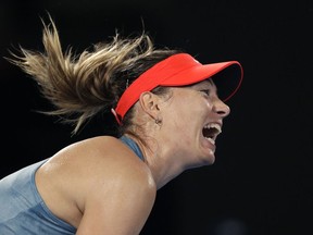 Russia's Maria Sharapova serves to Denmark's Caroline Wozniacki during their third round match at the Australian Open tennis championships in Melbourne, Australia, Friday, Jan. 18, 2019.