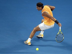 Spain's Rafael Nadal makes a backhand return to Greece's Stefanos Tsitsipas during their semifinal at the Australian Open tennis championships in Melbourne, Australia, Thursday, Jan. 24, 2019.