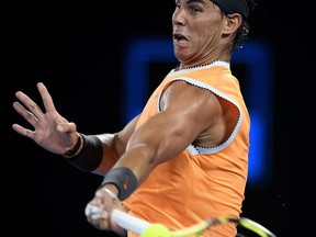 Spain's Rafael Nadal makes a forehand return to United States' Frances Tiafoe during their quarterfinal match at the Australian Open tennis championships in Melbourne, Australia, Tuesday, Jan. 22, 2019.