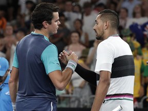 Canada's Milos Raonic, left, is congratulated by Australia's Nick Kyrgios after winning their first round match at the Australian Open tennis championships in Melbourne, Australia, Tuesday, Jan. 15, 2019.