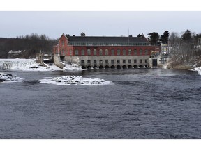In this Saturday, Jan. 19, 2019 photo, the Brookfield Renewable hydroelectric facility stands at the Milford Dam on the Penobscot River in Milford, Maine. A plan to test the use of a new technology to help endangered Atlantic salmon has been abandoned, at least for now. Brookfield spokesman Andy Davis said the project's architects discovered a "significant risk" to species other than salmon, such as river herring.