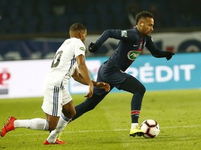 Strasbourg's Samuel Grandsir, left, nd PSG's Neymar challenge for the ball during the French Cup soccer match between Paris Saint Germain and Strasbourg at the Parc des Princes stadium in Paris, Wednesday, Jan. 23, 2019.