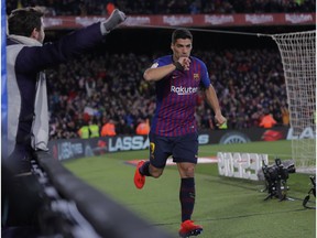 FC Barcelona's Luis Suarez celebrates after scoring during a Spanish Copa del Rey soccer match between FC Barcelona and Sevilla at the Camp Nou stadium in Barcelona, Spain, Wednesday, Jan. 30, 2019.