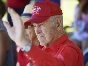 In this July 7, 2018 photo, Herb Teichman waves to the crowd during the 45th Annual International Cherry Pit-Spitting Championship at Tree-Mendus Fruit Farm in Eau Claire, Mich. Teichman, a lifelong Eau Claire fruit farmer and founder of the pit spitting championship died Monday, Jan. 14, 2019, at a Stevensville, Mich., hospice care facility. He was 88.