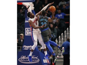 Dallas Mavericks forward Dorian Finney-Smith (10) shoots as Detroit Pistons guard Reggie Jackson (1) defends during the first half of an NBA basketball game Thursday, Jan. 31, 2019, in Detroit.