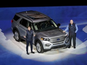 Ford Motor Co., President, Global Markets Jim Farley, left, and President and CEO Jim Hackett stand next to the redesigned 2020 Ford Explorer during its unveiling, Wednesday, Jan. 9, 2019, in Detroit. Ford's aging Explorer big SUV is getting a major revamp as it faces growing competition in the market for family haulers with three rows of seats.