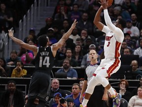 Miami Heat guard Dwyane Wade (3) shoots as Detroit Pistons guard Ish Smith (14) defends during the first half of an NBA basketball game, Friday, Jan. 18, 2019, in Detroit.