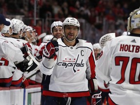 Washington Capitals left wing Alex Ovechkin greets teammates after Tom Wilson scores on Detroit Red Wings goaltender Jimmy Howard during the first period of an NHL hockey game, Sunday, Jan. 6, 2019, in Detroit.